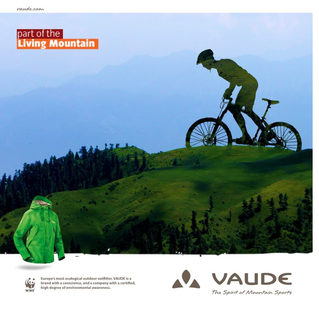 Composition of a biker with a mountain hill and a wind jacket