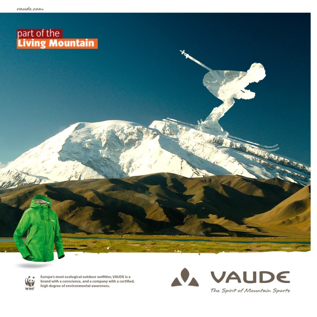 Composition of a skier on a snowy mountain top and a wind jacket